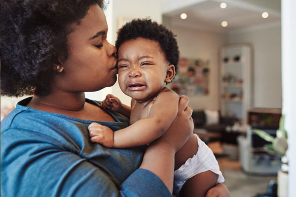 Ontdek wat je baby wil duidelijk maken Vrouw troost huilende baby